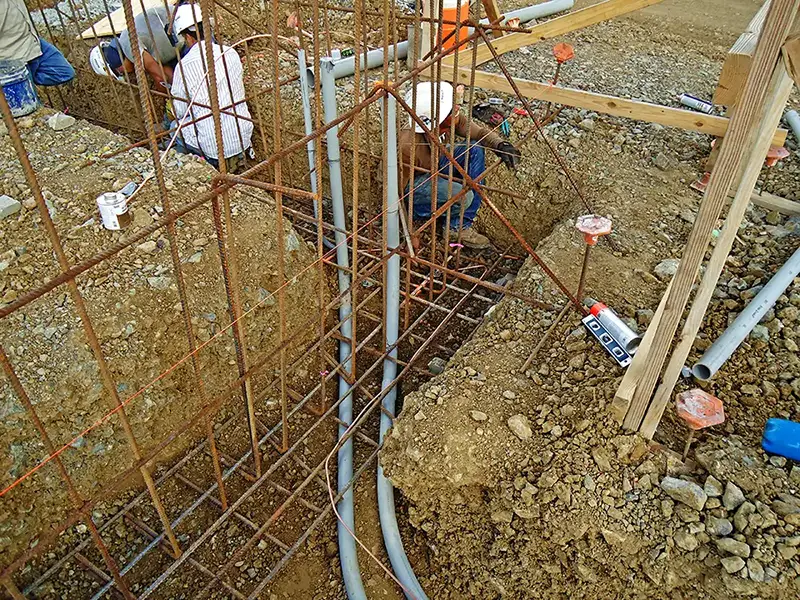 dirt trench with electrical wiring on construction site