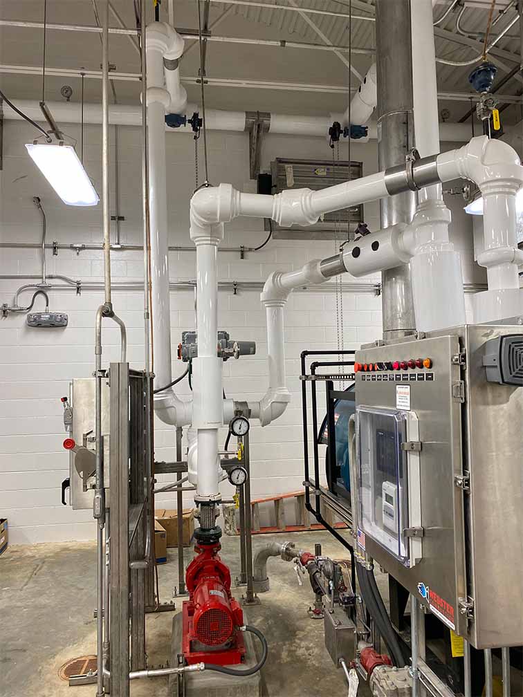 pipes coming out of a panel in a concrete building