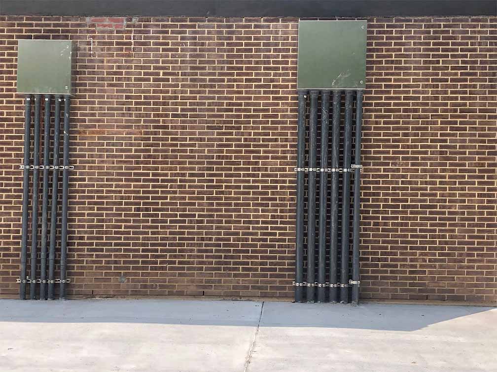electrical wiring on exterior of brick building